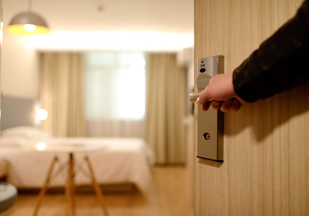 a close up of hotel staff opening up the hotel room door